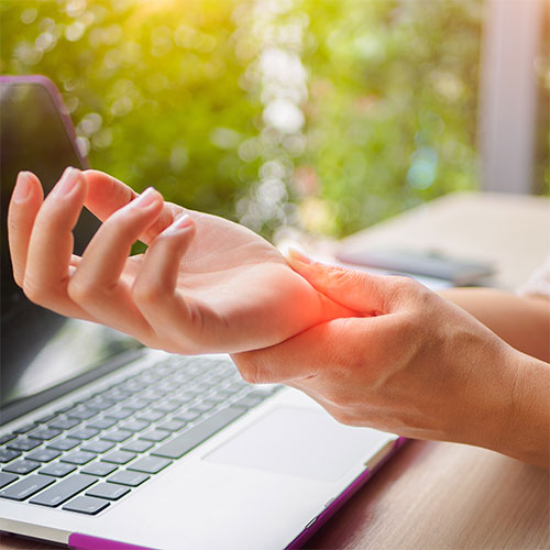 woman holding painful wrist