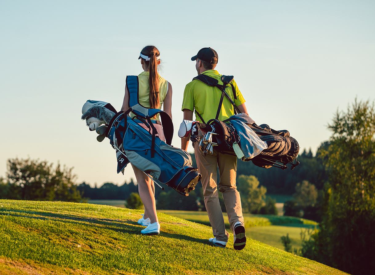 golfing couple walking
