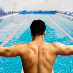 man preparing to swim indoors