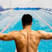 man preparing to swim indoors